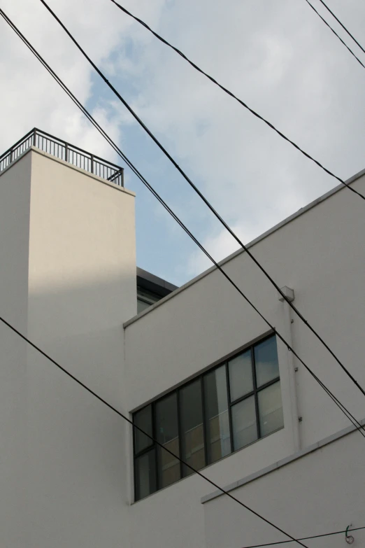 the corner of an apartment building is covered by lines and wires