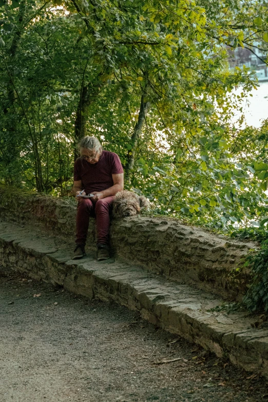 a man sits alone on some steps by the river