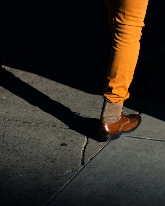 a person standing on the side of the road with a pair of shoes on