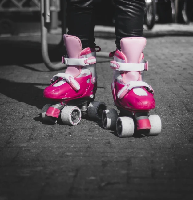 a close up of a pair of pink skates