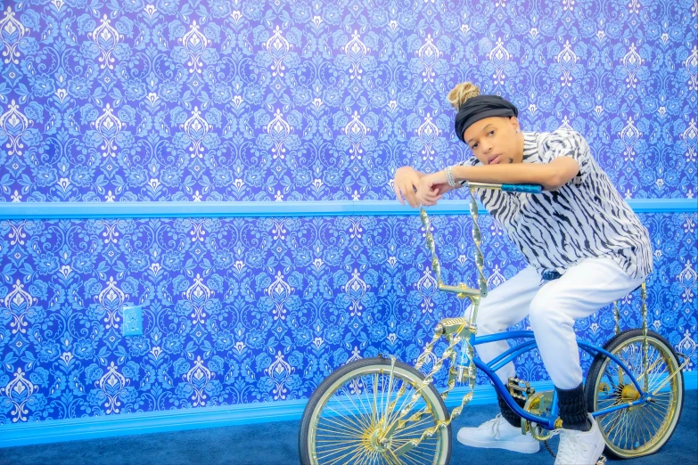 a boy riding a bicycle and jumping up in the air