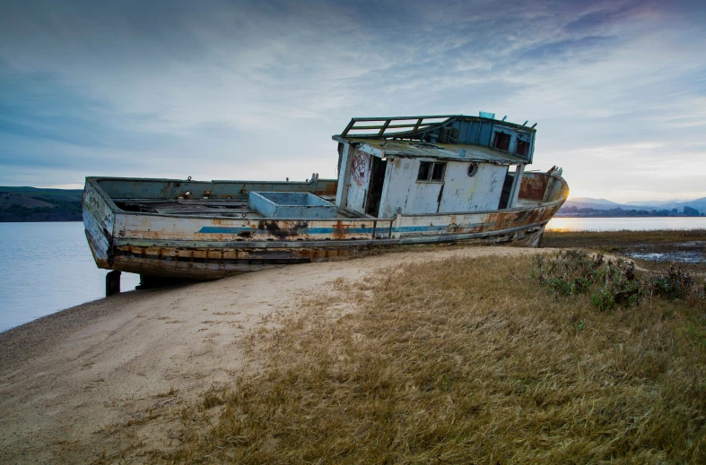 a boat is on the shore of a lake