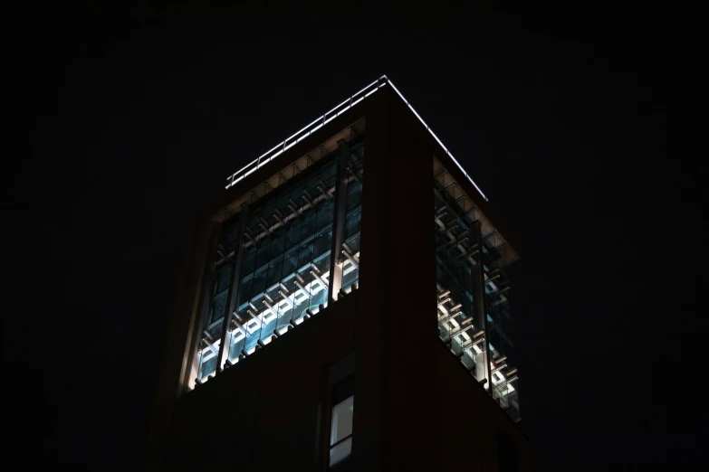 the building is dark with a very tall clock