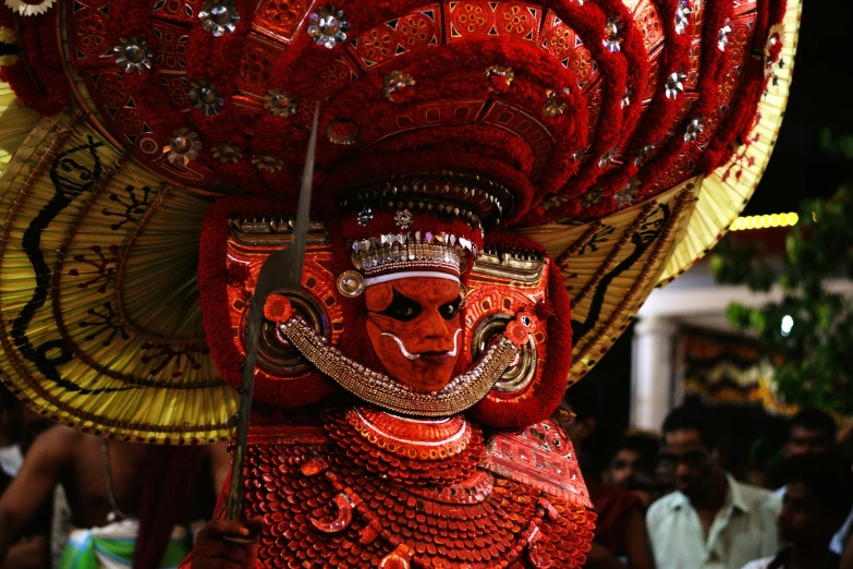 a man in a costume with two hands on his head