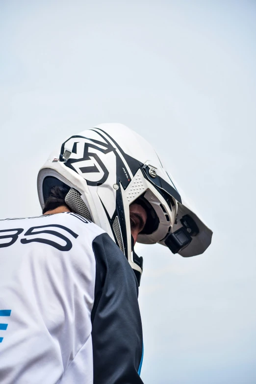 a person in a white jersey with a black helmet