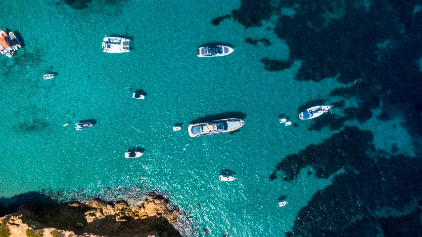 this aerial po shows several boats anchored in blue waters