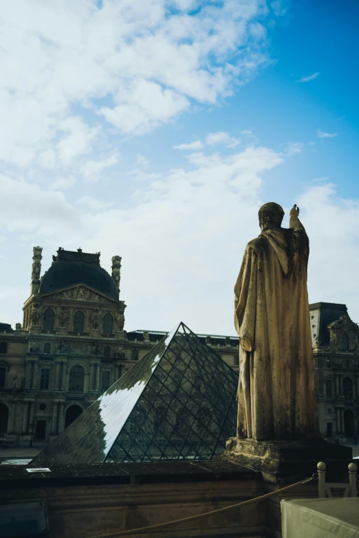 a statue sits in the middle of the city