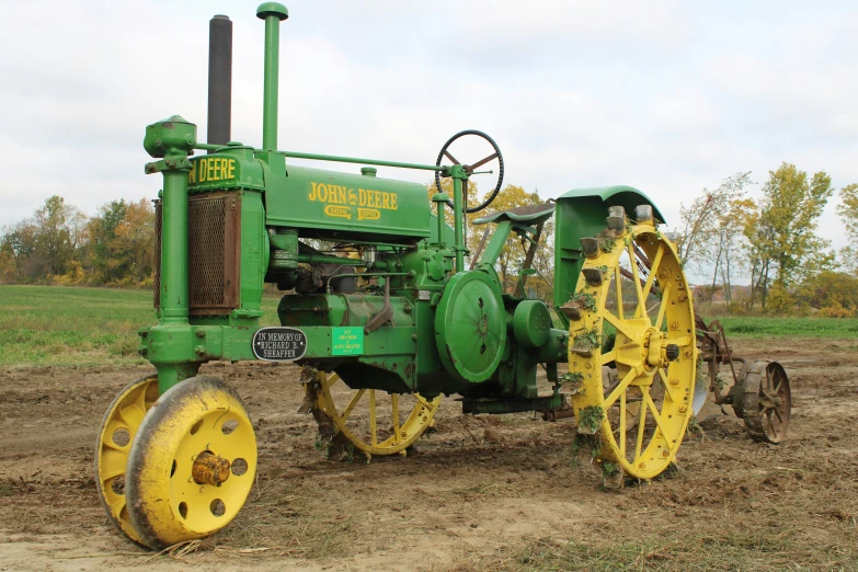 a tractor in a field with yellow wheels