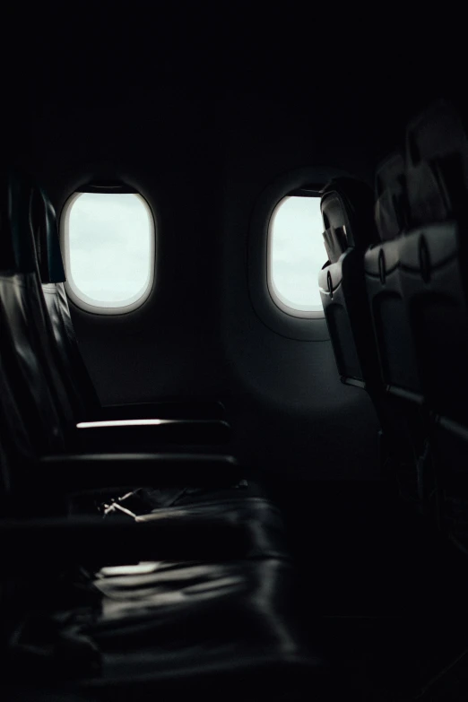 view of an airplane from the inside with a lot of seats and small windows