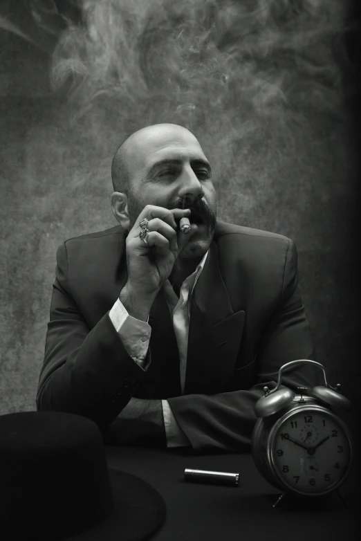 black and white po of man sitting at desk eating with an open mouth and a broken watch, a cigar in his hand