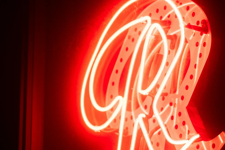 a close up of a neon sign with light from the bottom