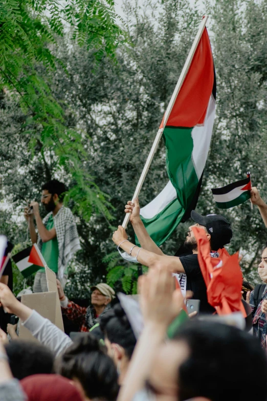 some people are protesting a rally with flags