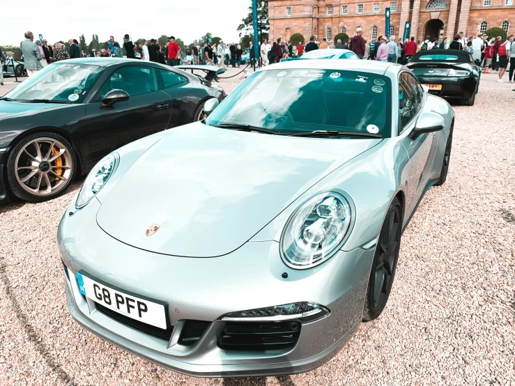 a porsche car parked in front of a building