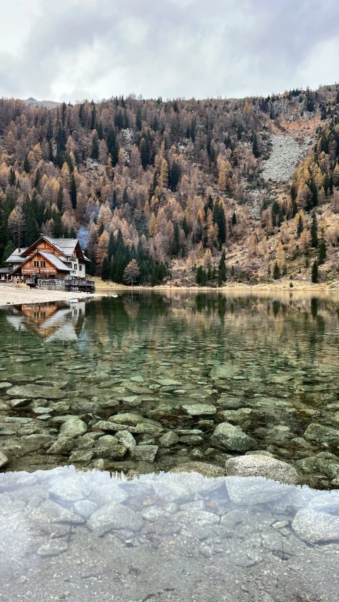 a lake with ice on it and some trees in the background