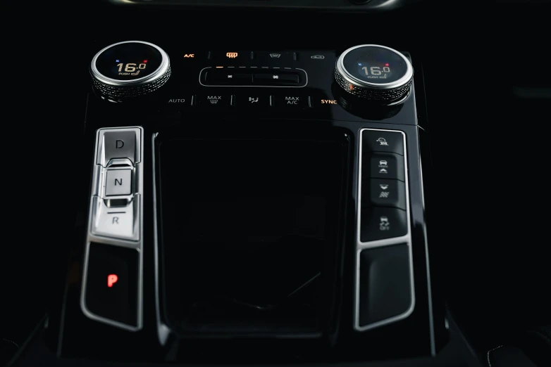 a black car dashboard with ons on it