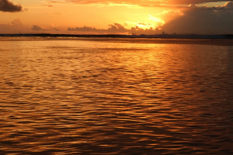 the sun is shining on the water, and it looks like the sky is reflected