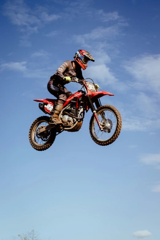 man in the air on dirt bike during a jump