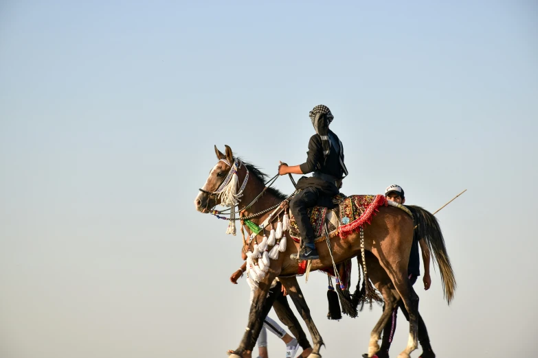 a man on the back of a horse carrying another