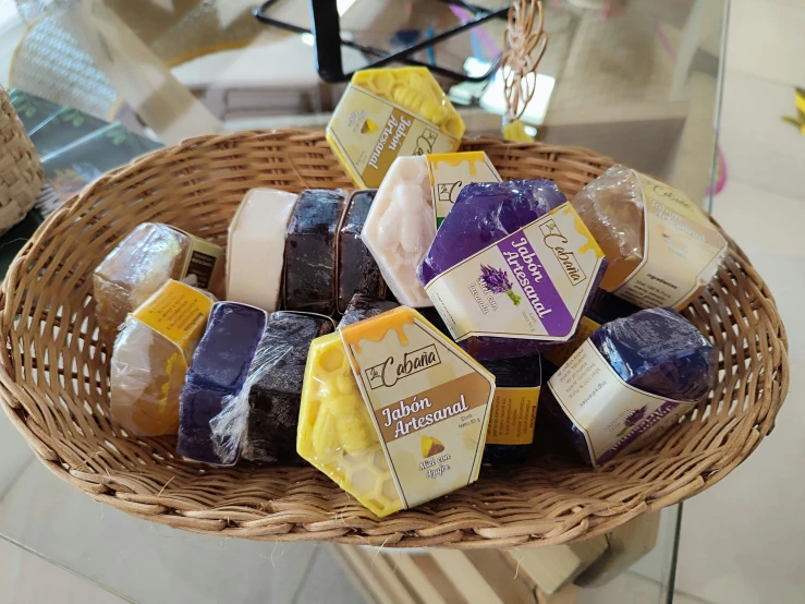 a bunch of soaps are placed in a basket