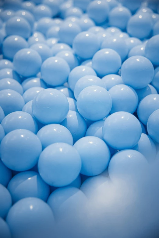 a pile of balls sitting in the middle of blue