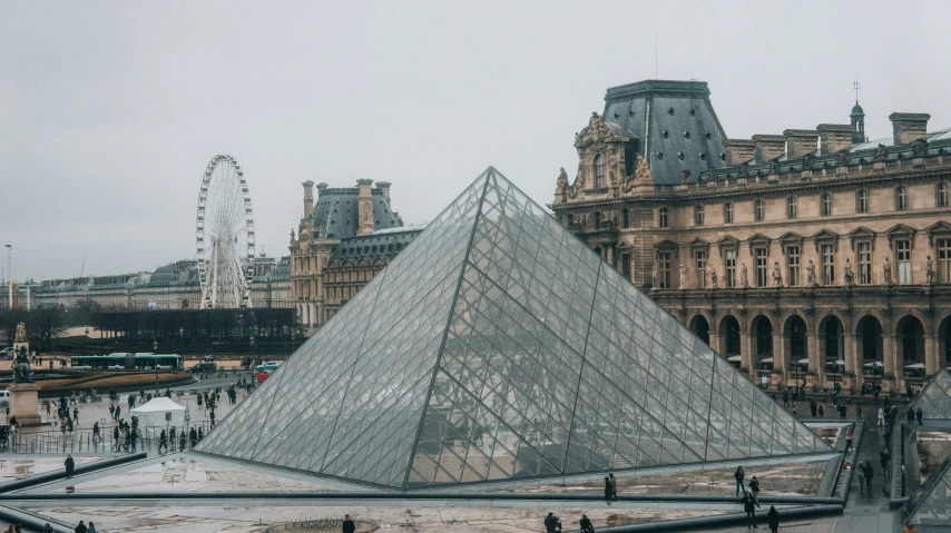 the pyramid shaped building stands out among the other buildings