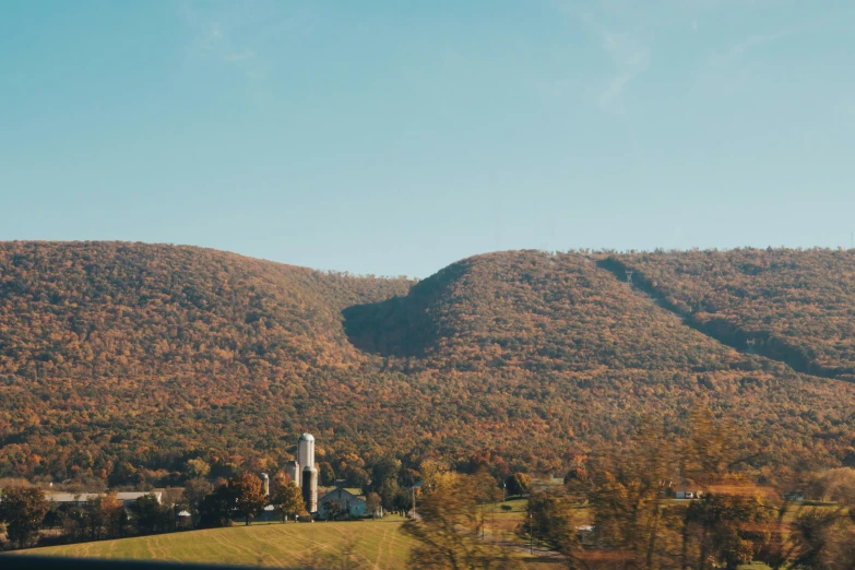 a farm and mountains in a rural area