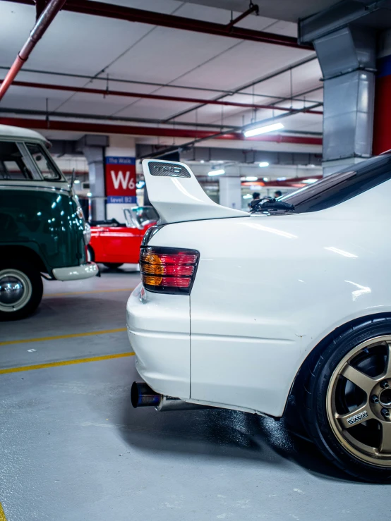 white toyota sits parked inside of a garage