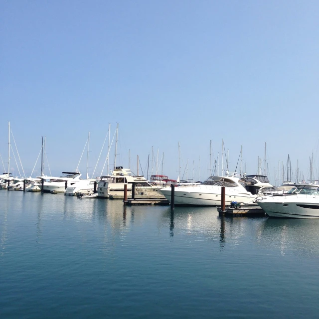 a dock with many boats and people on it