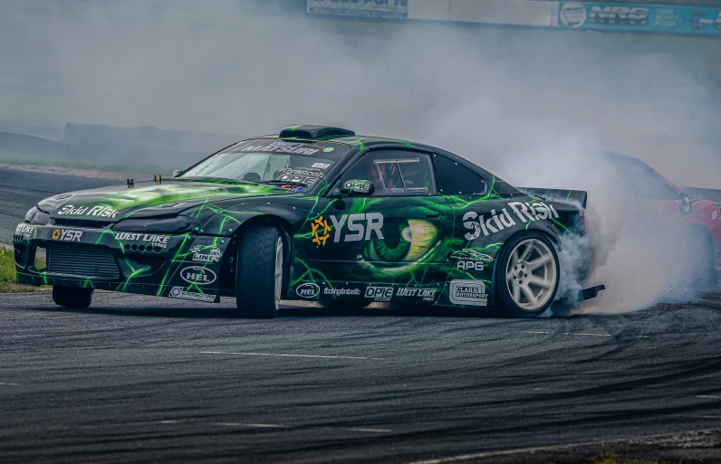 a race car kicking up smoke during a stunt