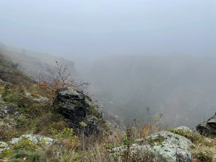 a rocky hillside with a mountain in the background