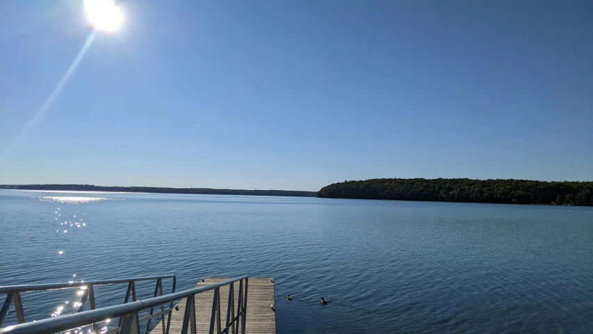 a dock over a body of water on a sunny day