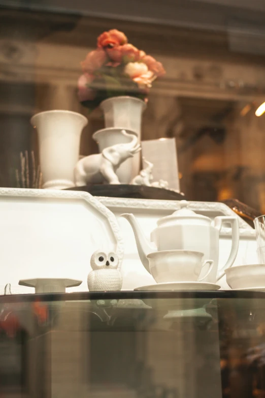 cups are sitting on top of a display shelf