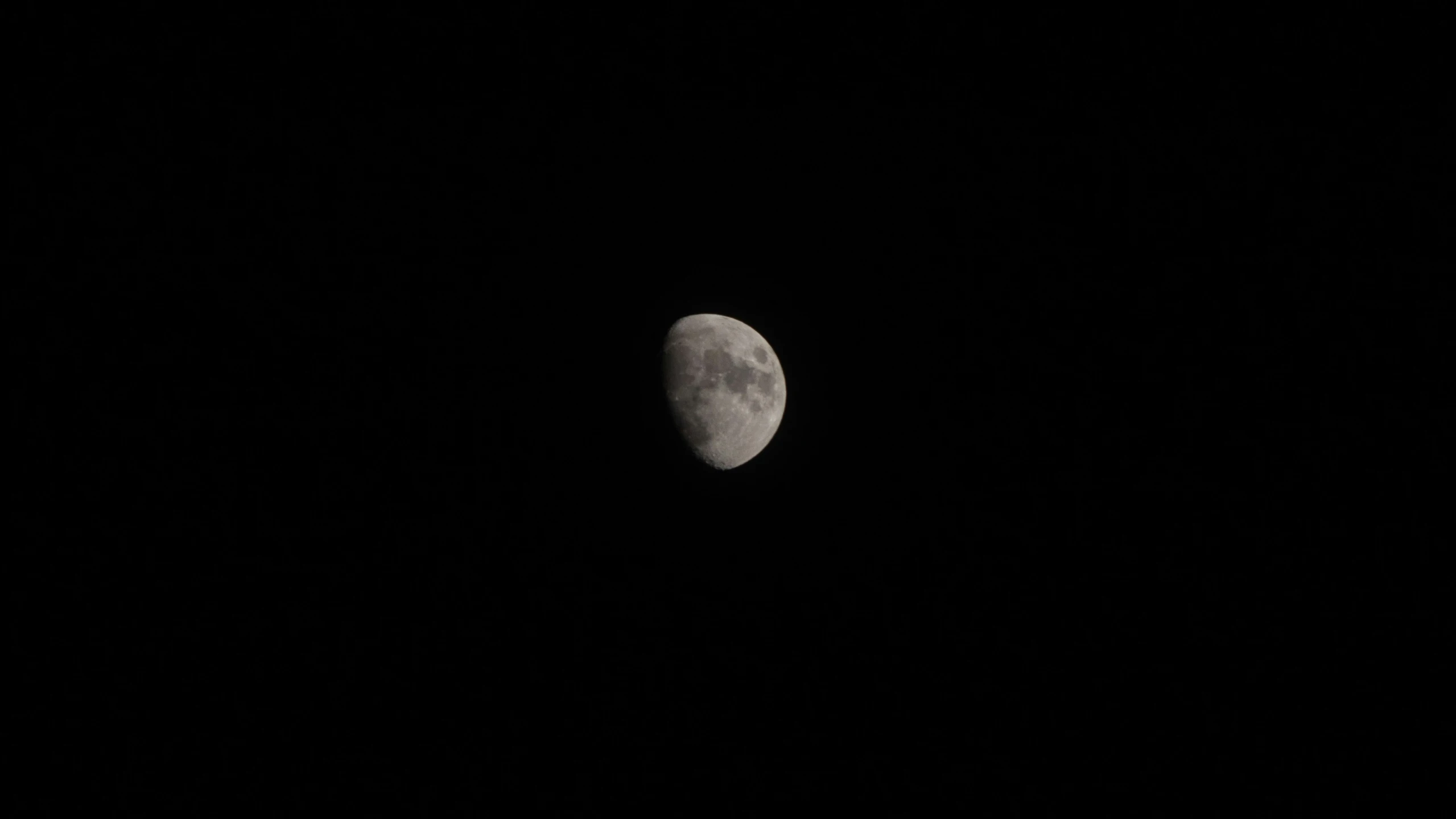 the full moon is seen through a dark night sky