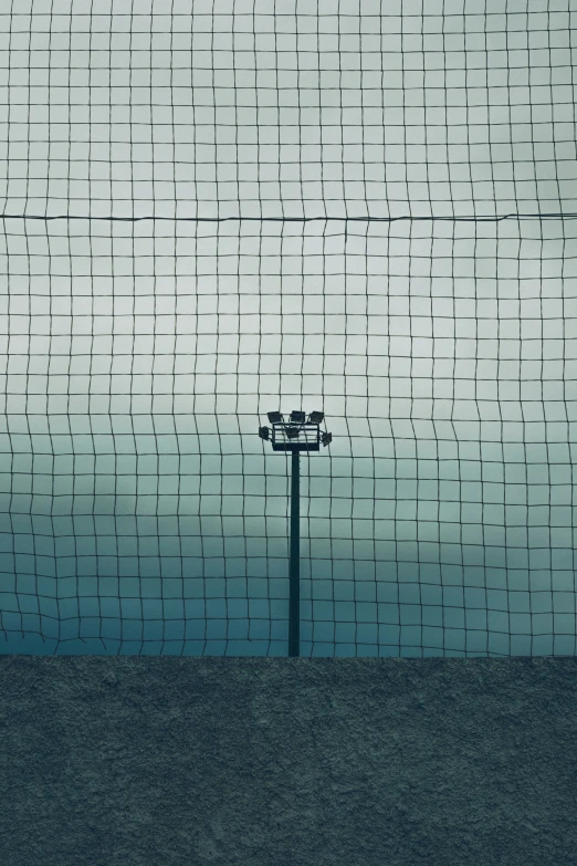 a lone street light against a blue and grey sky