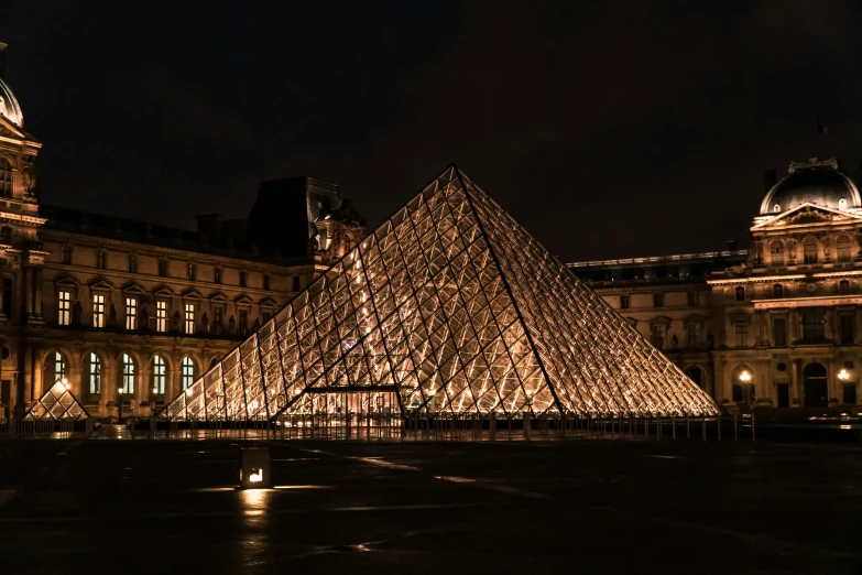 a pyramid type structure lit up in the dark