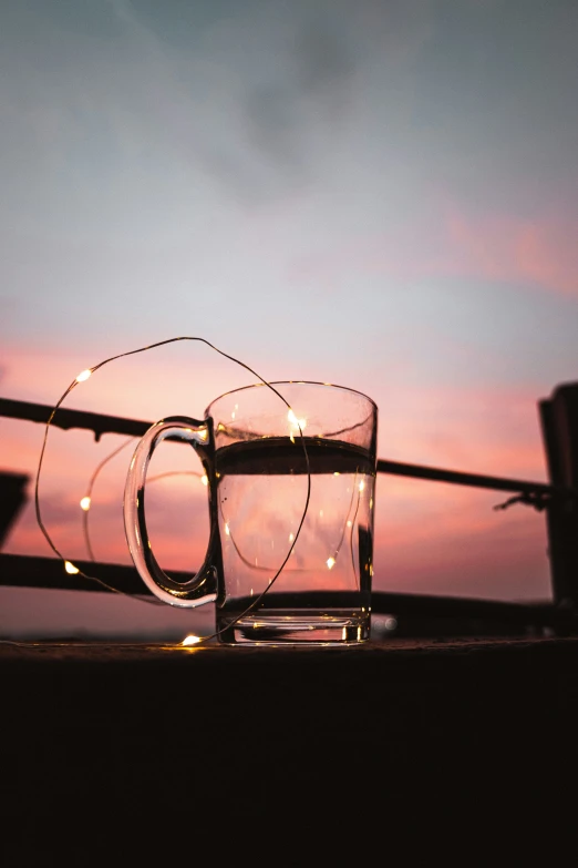 a cup with a light in the middle on a table