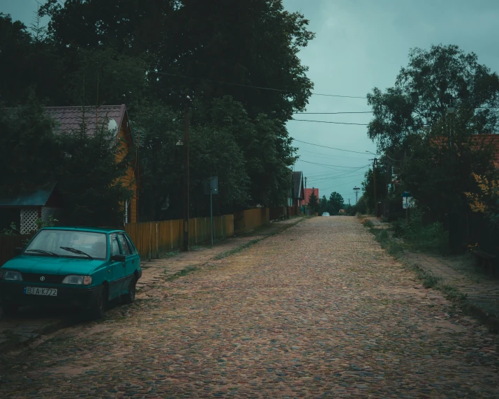 there is a car parked on the side of this empty street