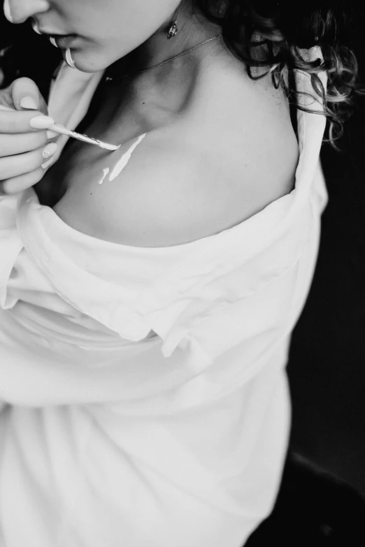 a woman in white shirt brushing teeth next to another woman