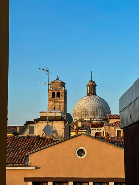 a view of a small town with a building and bell towers