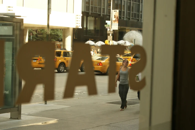 a woman walking past an outside sign that reads chicago