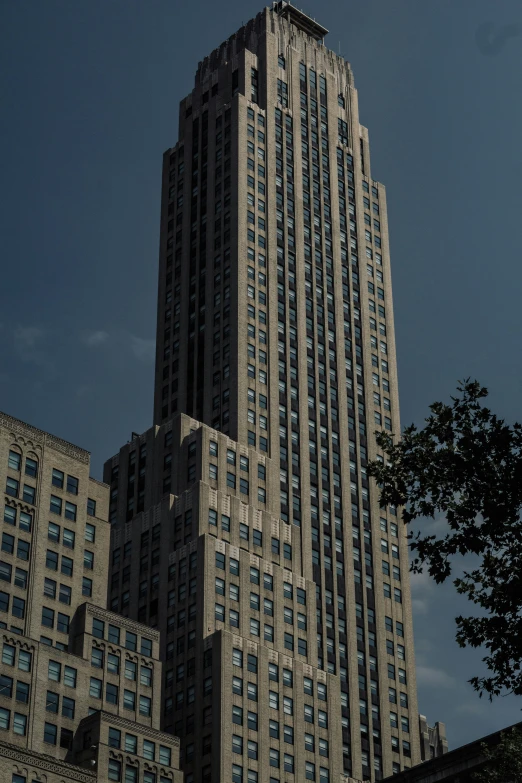 the side view of a large skyscr, some of the building has glass and concrete details