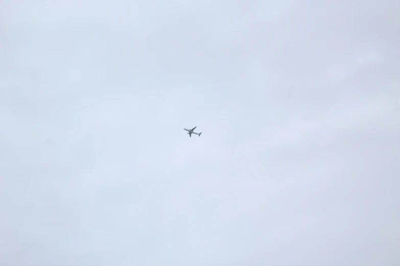 an airplane is flying through a blue cloudy sky