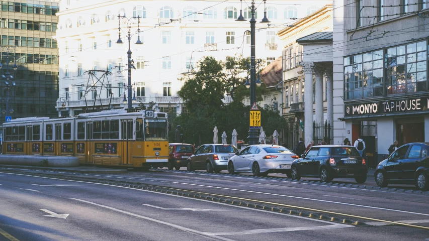 a public transit bus sitting at the corner of a busy street