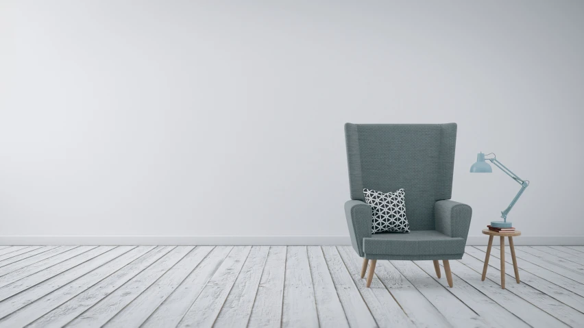 a grey chair with a pillow sitting in it