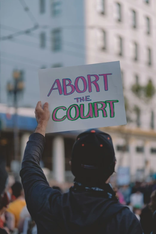 a protester holds up a sign in the street