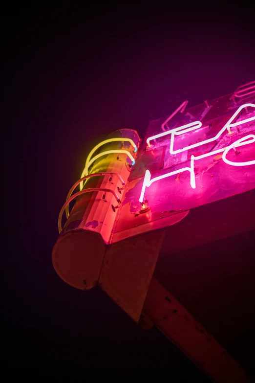 the neon sign for pizza hut in front of a building