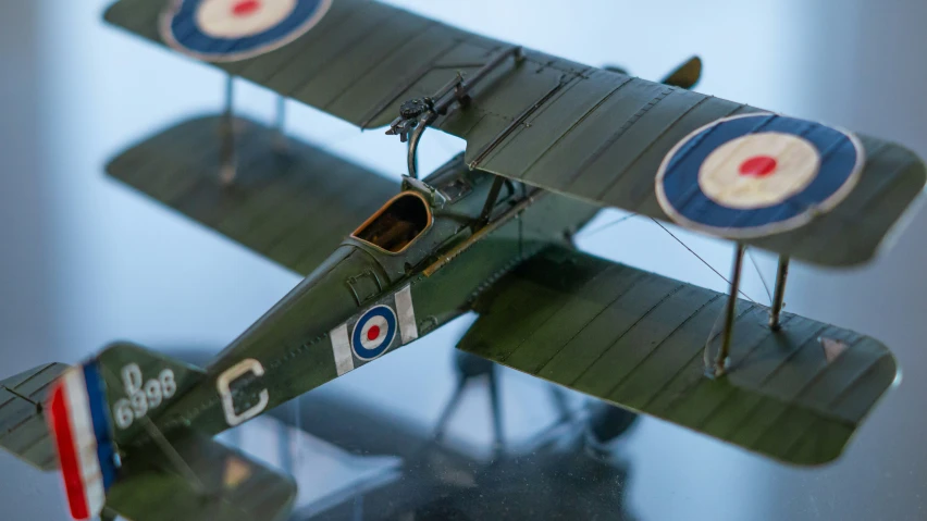 model airplane displayed on pedestal in indoor setting