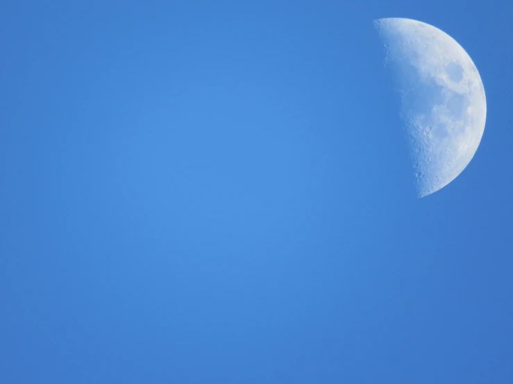 the view from a plane flying by with the moon in the background