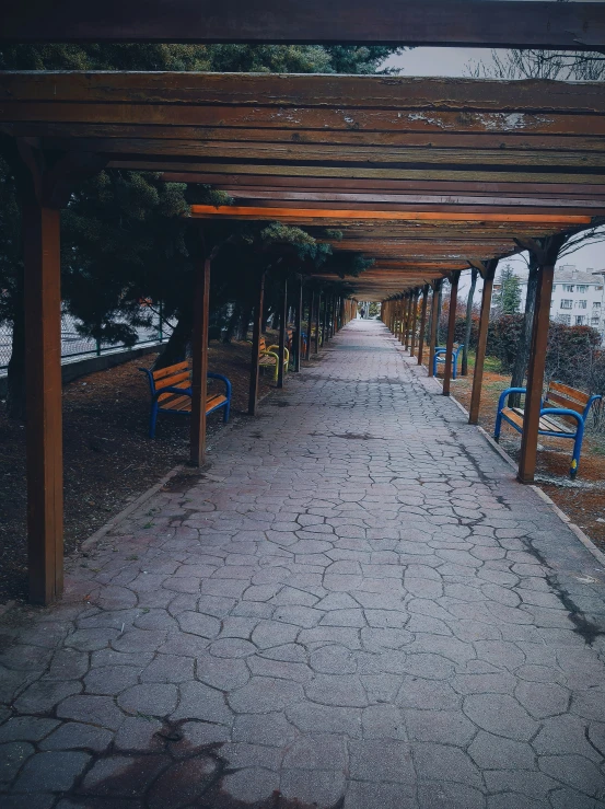 the walkway is next to a lake in the park