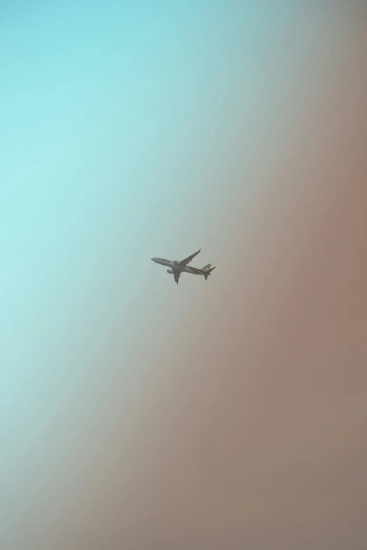 a plane flies over an area with hazy sky